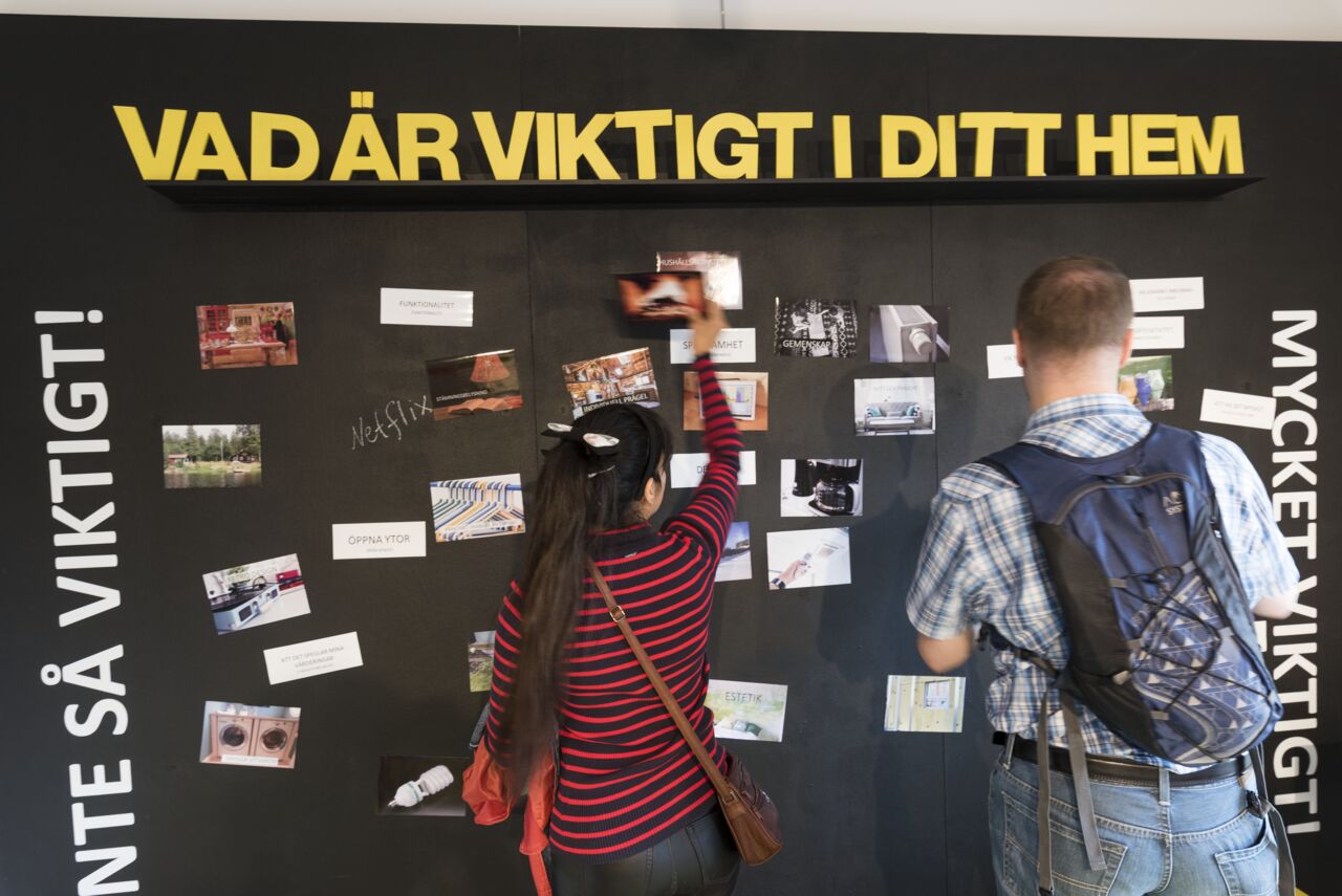 People looking at wall.