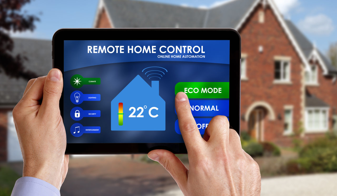  Smart power grids - person using a tablet to control the electricity grids in his home