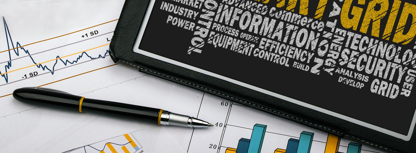 Pencil, diagram and a tablet with word clouds about smart grid